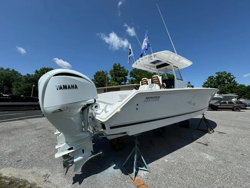 Slide: The Image of 2024 Jupiter 340LS boat with Yamaha engine on display outdoors. - 5