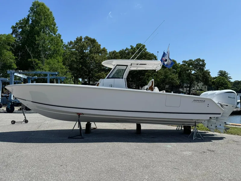 Slide: The Image of 2024 Jupiter 340LS boat on display, white hull, outdoor setting. - 8