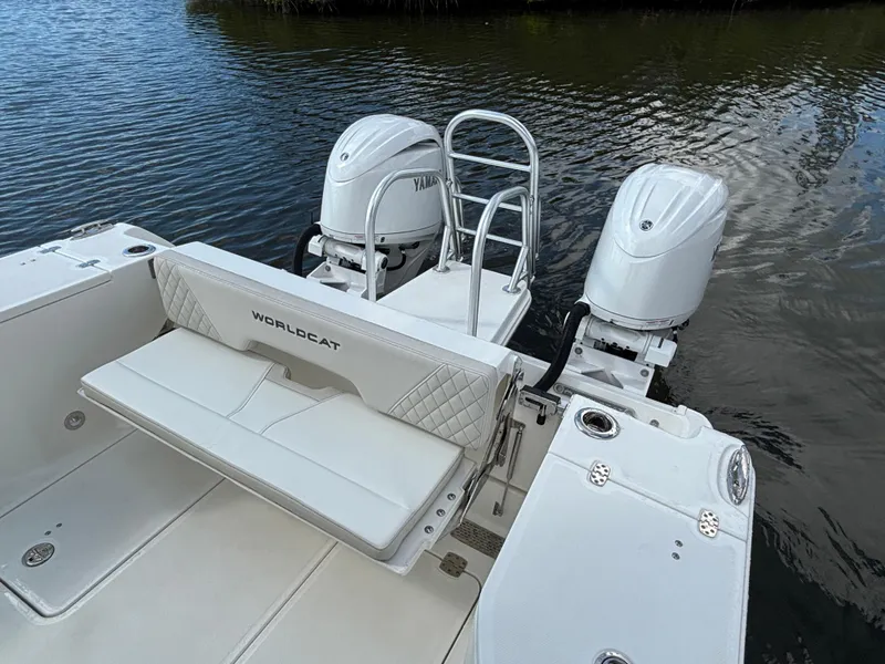 Slide: The Image of 2025 World Cat 260 CC-X boat with dual engines and seating, on calm water. - 15