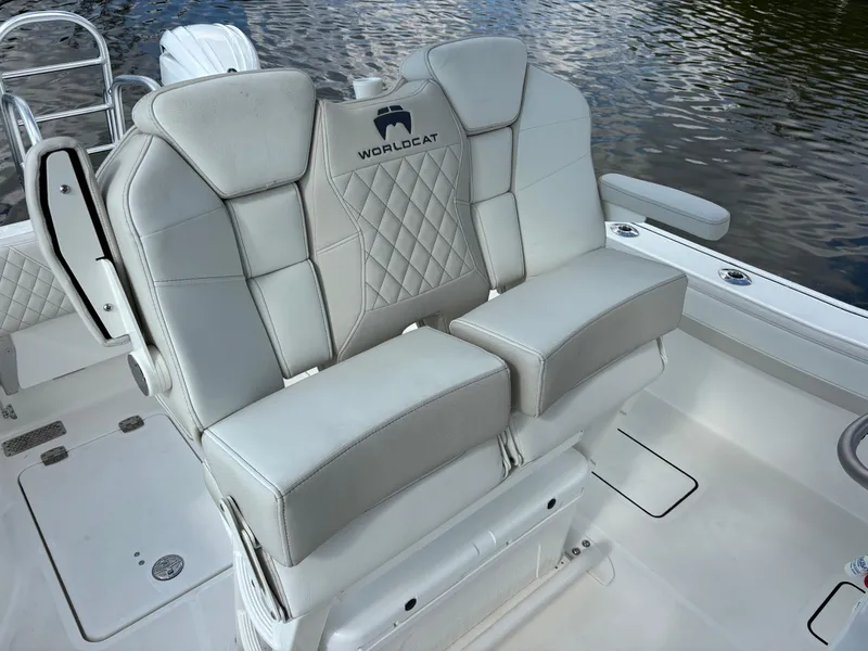 Slide: The Image of 2025 World Cat 260 CC-X boat seating with quilted design, on calm water. - 16