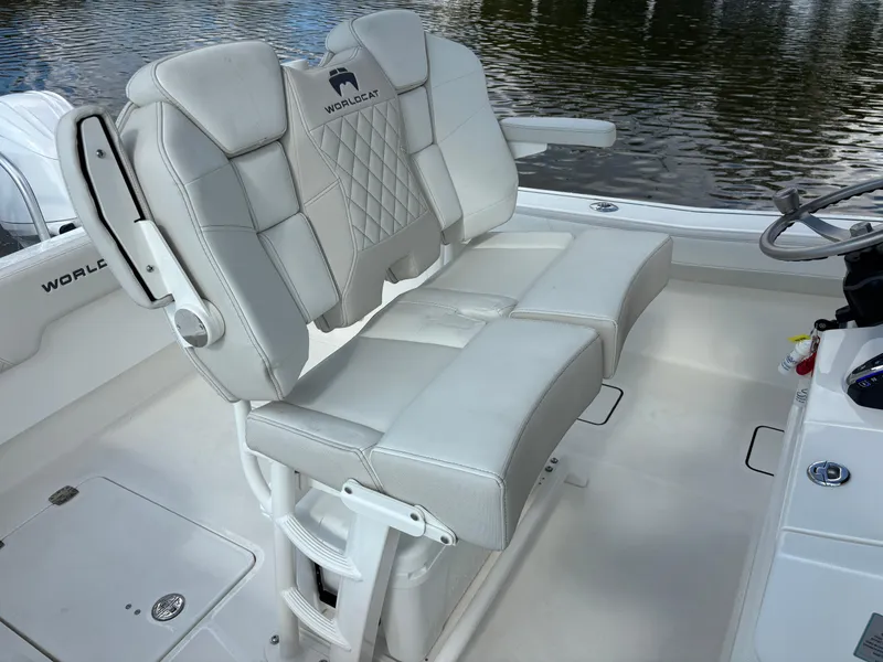 Slide: The Image of 2025 World Cat 260 CC-X boat interior with plush seating and steering console. - 17
