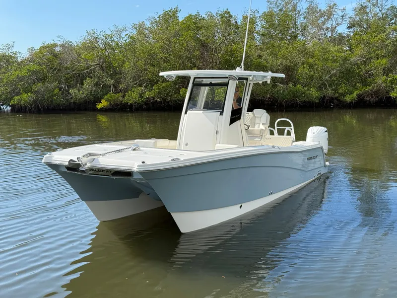 Slide: The Image of 2025 World Cat 260 CC-X boat on calm water, surrounded by lush greenery. - 3