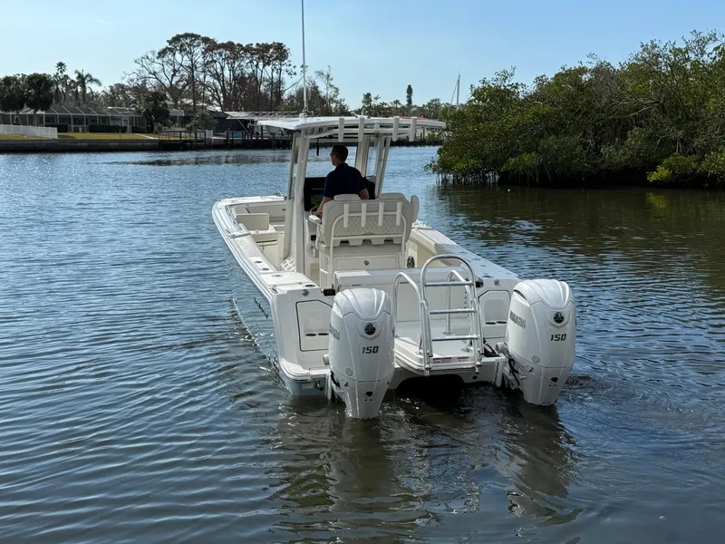 Slide: The Image of 2025 World Cat 260 CC-X boat with dual engines navigating a calm waterway. - 5