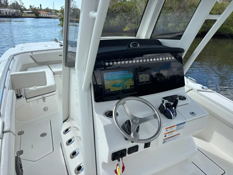 Slide: The Image of 2025 World Cat 260 CC-X boat interior with modern dashboard and steering wheel. - 6