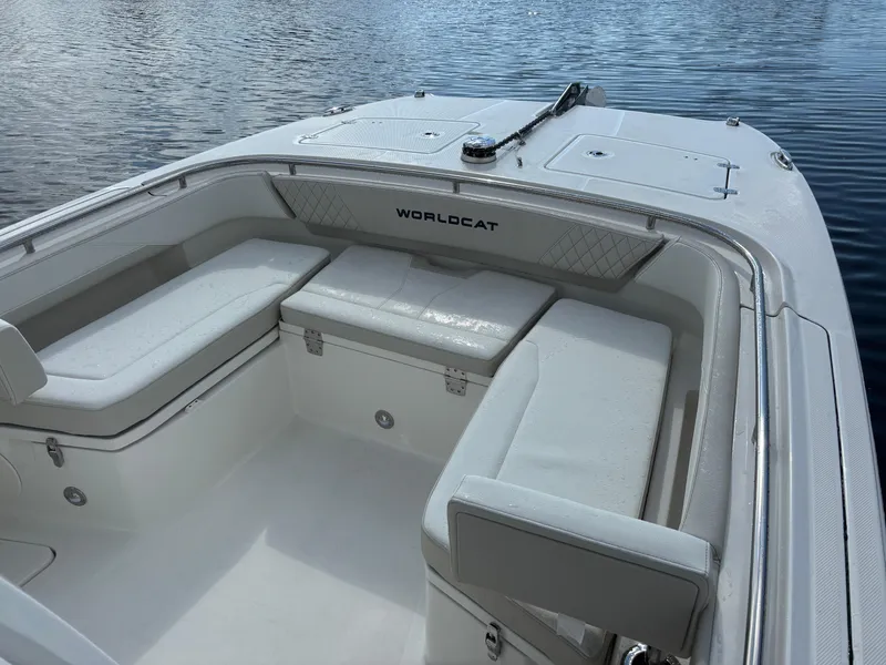 Slide: The Image of 2025 World Cat 260 CC-X boat interior with white seating on calm water. - 8