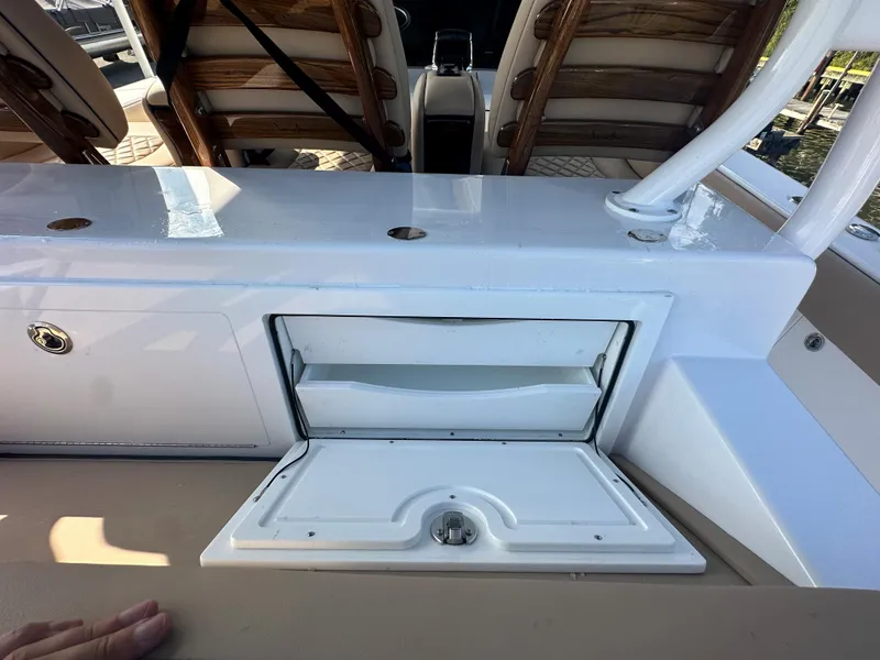Slide: The Image of 2024 Jupiter 43 boat interior with open storage compartment and seating. - 15