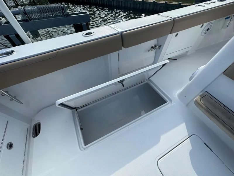 Slide: The Image of 2024 Jupiter 43 boat deck with open storage compartment. - 16