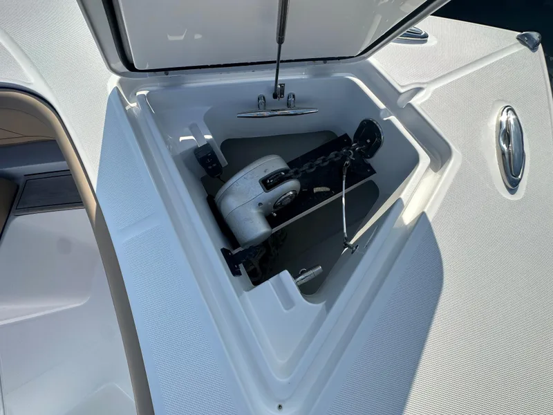 Slide: The Image of Open anchor compartment on 2024 Jupiter 43 boat, showcasing anchor and chain storage. - 18