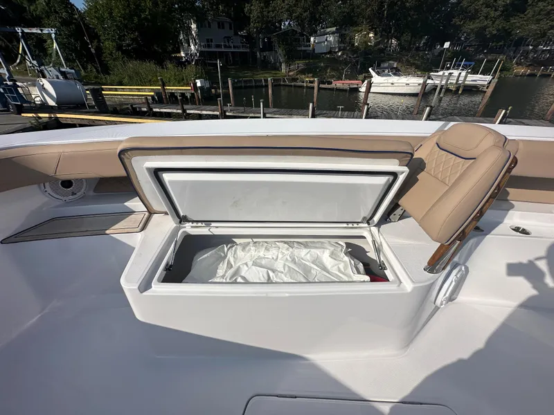 Slide: The Image of Open storage compartment on 2024 Jupiter 43 boat, docked near waterfront. - 19