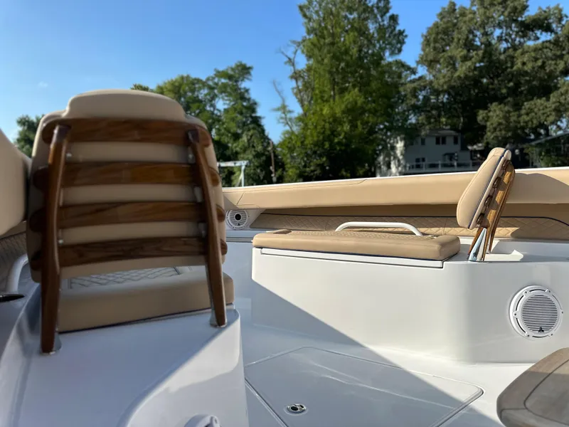 Slide: The Image of 2024 Jupiter 43 boat interior with cushioned seating and wooden accents. - 25