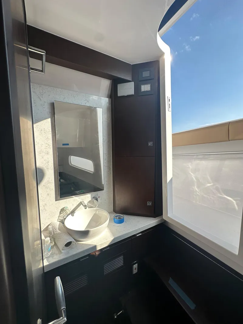 Slide: The Image of Luxurious bathroom in 2024 Jupiter 43 yacht with modern fixtures and large window. - 28