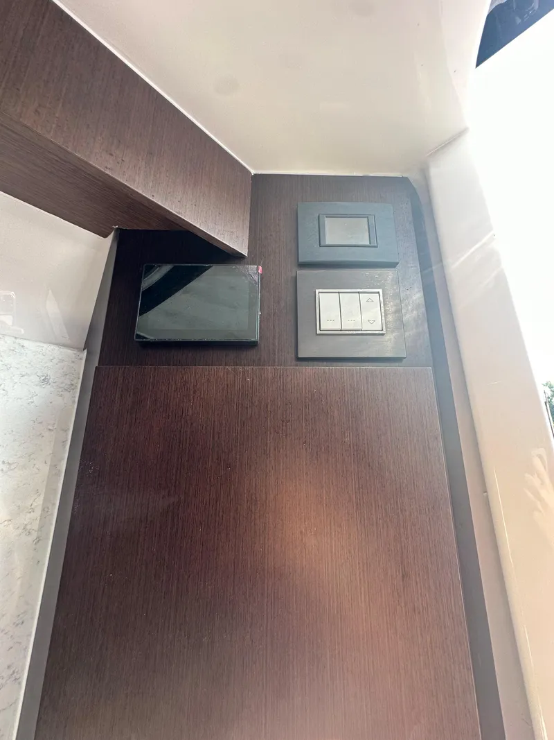 Slide: The Image of 2024 Jupiter 43 interior with modern light switches on a wooden panel. - 31