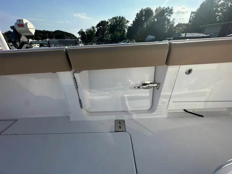 Slide: The Image of 2024 Jupiter 43 boat interior with tan seating and storage compartment. - 34