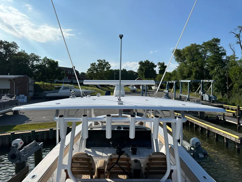 Slide: The Image of 2024 Jupiter 43 boat docked at marina under clear blue sky. - 35