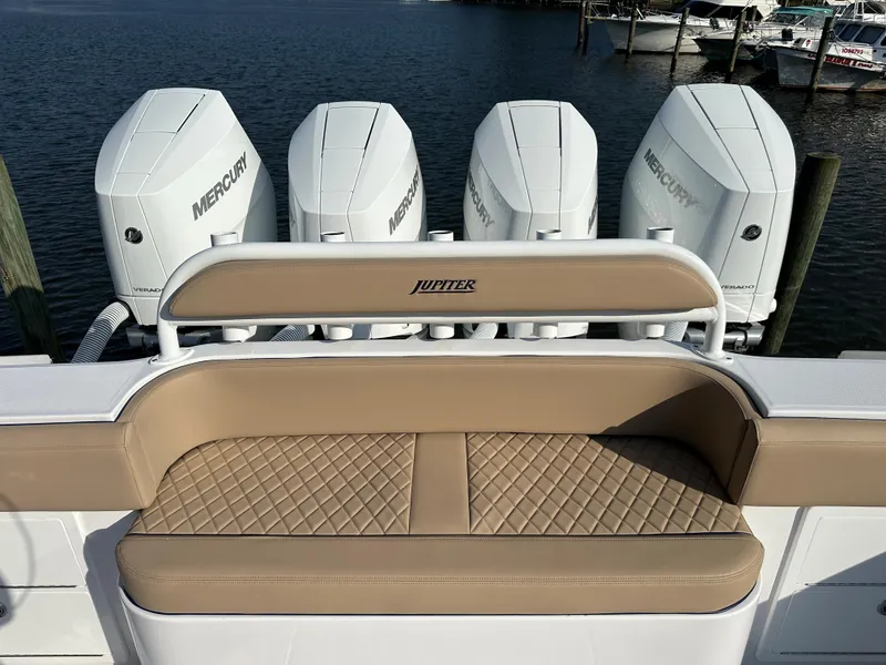 Slide: The Image of 2024 Jupiter 43 boat with quad Mercury engines and tan quilted seating. - 4
