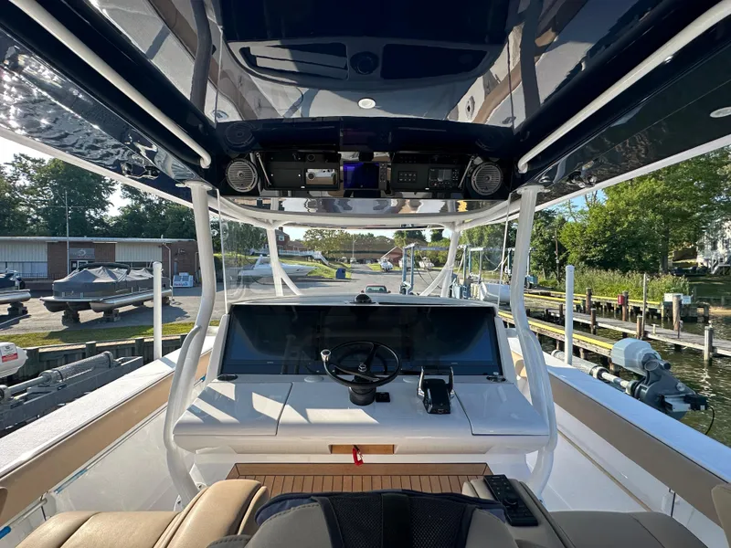 Slide: The Image of 2024 Jupiter 43 boat helm with advanced navigation system and sleek design. - 43