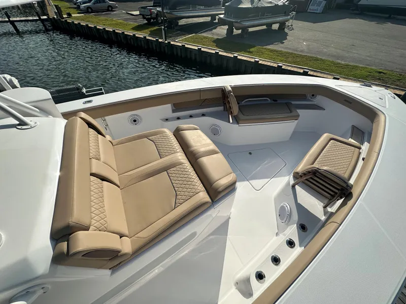 Slide: The Image of Luxurious seating on 2024 Jupiter 43 boat, docked by the water. - 48