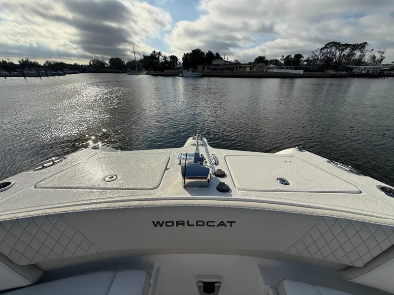 Slide: The Image of 2025 World Cat 325 DC boat on calm water, scenic view. - 11