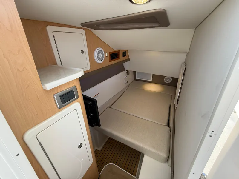 Slide: The Image of 2025 World Cat 325 DC cabin interior with compact bed and storage. - 17