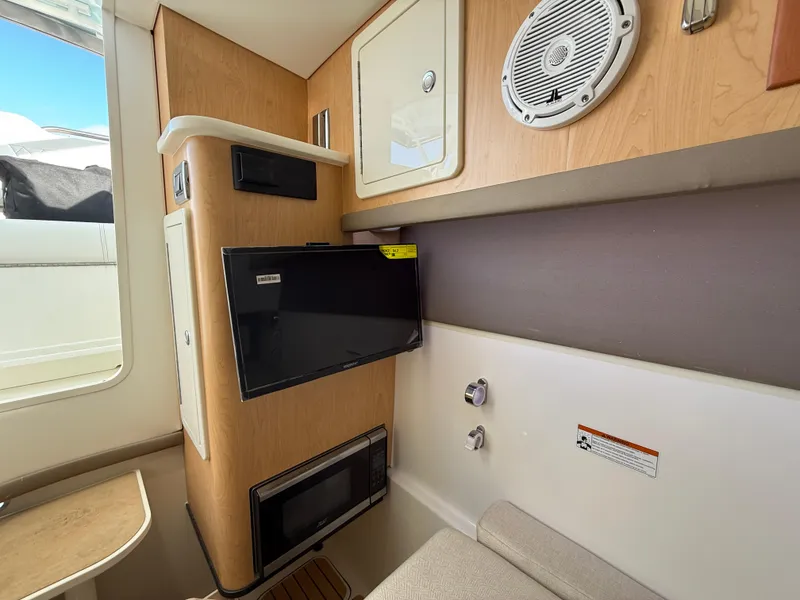 Slide: The Image of Interior of 2025 World Cat 325 DC boat with modern amenities and wood finish. - 18