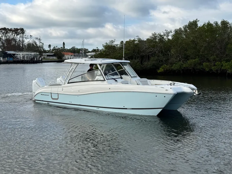 Slide: The Image of 2025 World Cat 325 DC cruising on a calm river with lush greenery. - 2