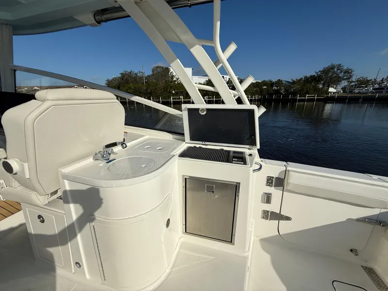 Slide: The Image of 2025 World Cat 325 DC boat interior with sink and grill by the water. - 30