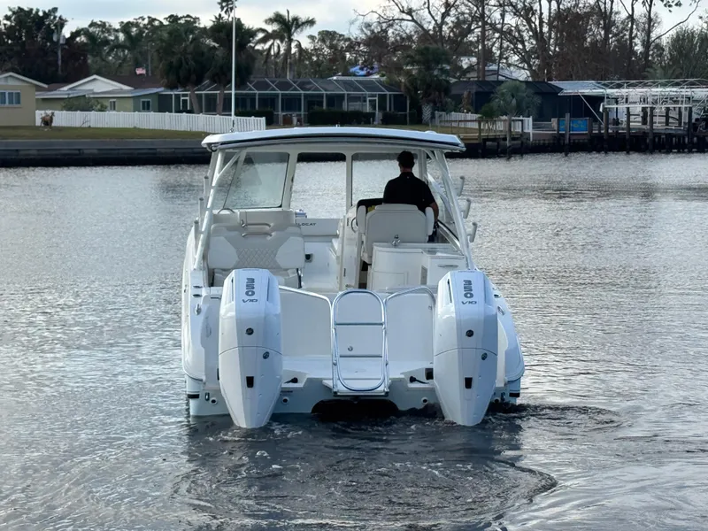 Slide: The Image of 2025 World Cat 325 DC boat cruising on a calm waterway. - 8