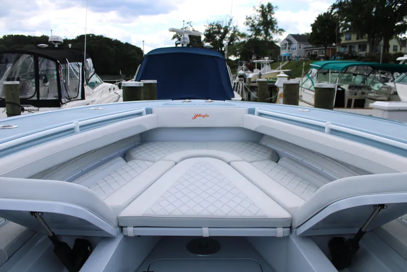 Slide: The Image of 2024 Yellowfin 36 Offshore boat with spacious seating at a marina. - 16