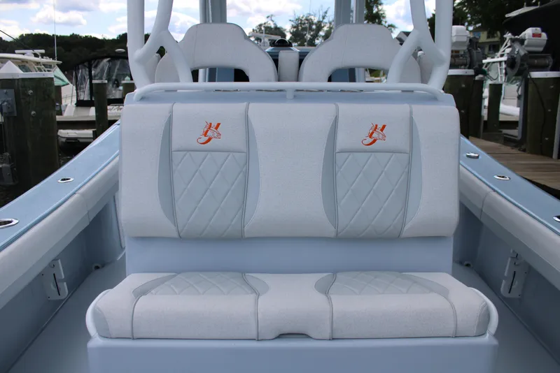 Slide: The Image of 2024 Yellowfin 36 Offshore boat seating with embroidered logos, docked at marina. - 19