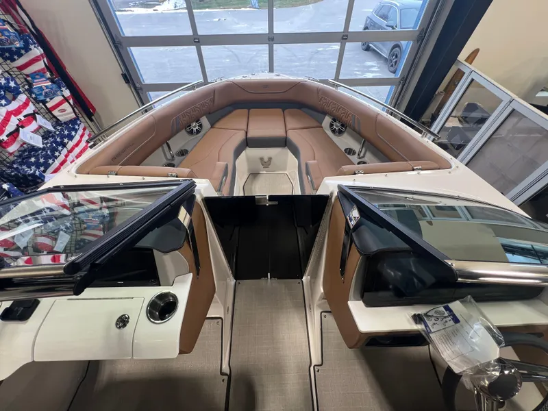Slide: The Image of 2025 Regal LS4 boat interior with tan seating and modern dashboard. - 11