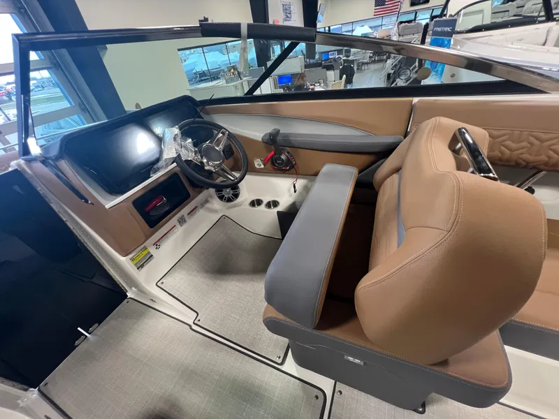 Slide: The Image of 2025 Regal LS4 boat interior with modern dashboard and tan seating. - 13