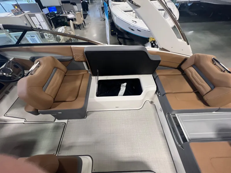 Slide: The Image of 2025 Regal LS4 boat interior with brown seating and storage compartment. - 14