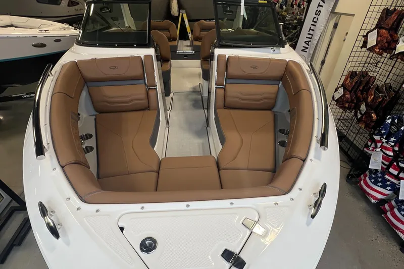 Slide: The Image of 2025 Regal LS4 boat interior with tan leather seating in showroom. - 17