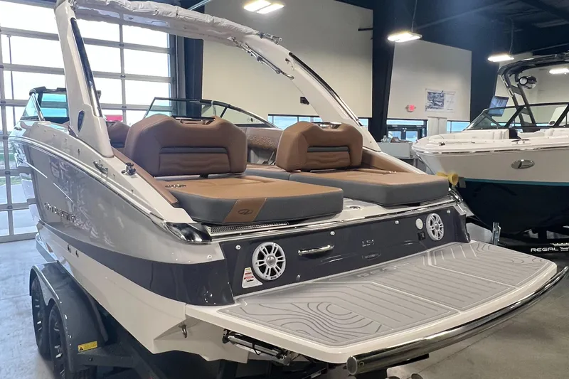 Slide: The Image of 2025 Regal LS4 boat in showroom, featuring sleek design and modern amenities. - 18