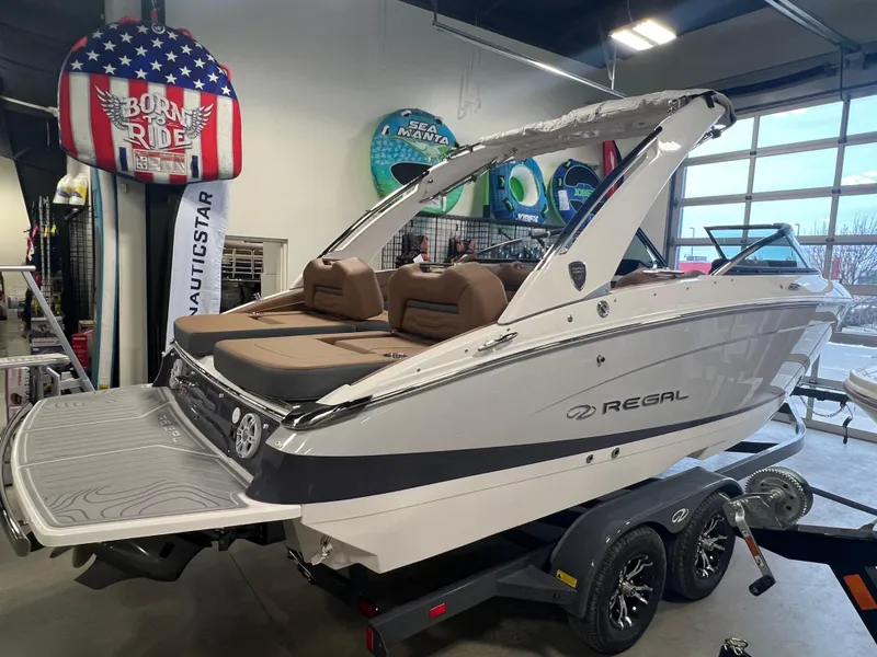 Slide: The Image of 2025 Regal LS4 boat in showroom, featuring sleek design and modern amenities. - 2