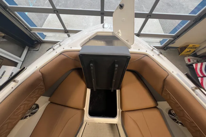 Slide: The Image of 2025 Regal LS4 boat interior with tan seating and storage compartment. - 21