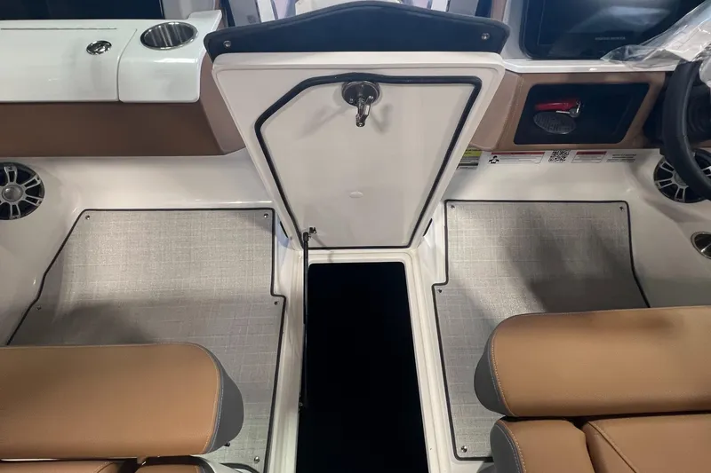 Slide: The Image of Interior of 2025 Regal LS4 boat with tan seats and modern dashboard. - 23
