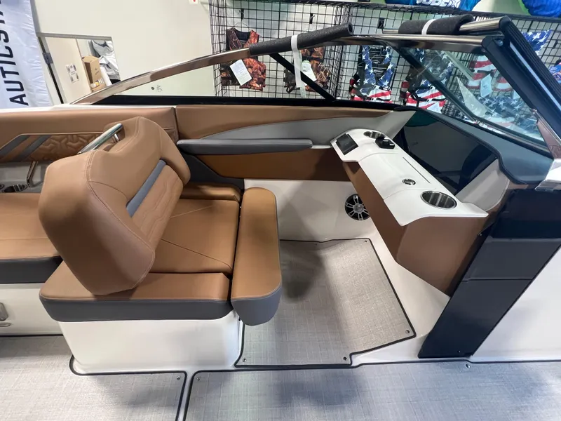 Slide: The Image of 2025 Regal LS4 boat interior with brown seating and modern dashboard design. - 5