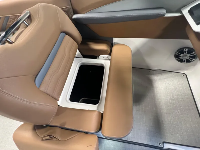 Slide: The Image of 2025 Regal LS4 boat seat with storage compartment, brown upholstery, and modern design. - 6