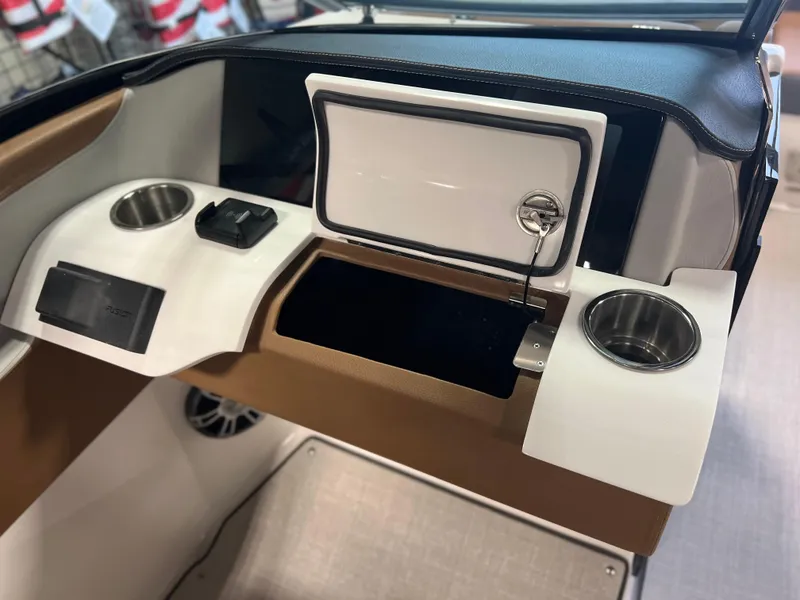 Slide: The Image of 2025 Regal LS4 boat dashboard with cup holders and storage compartment. - 8