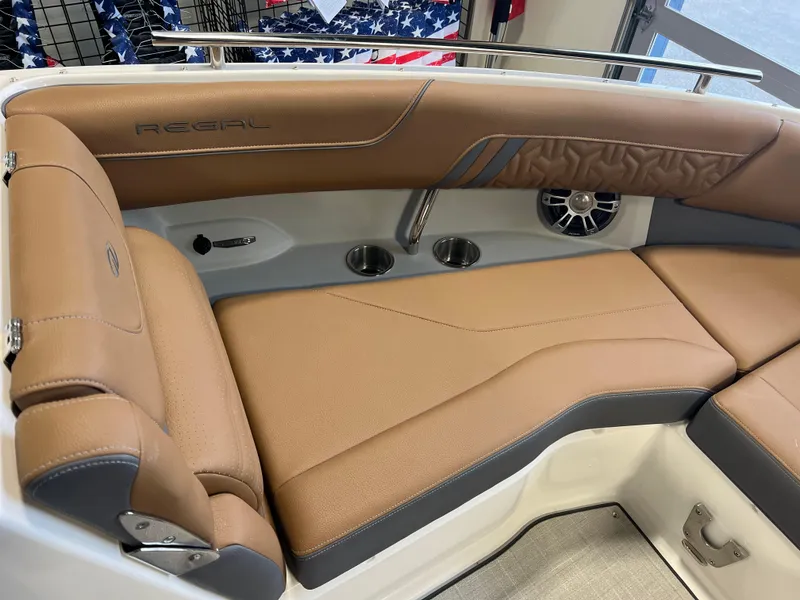 Slide: The Image of 2025 Regal LS4 boat interior with tan leather seating and cup holders. - 9