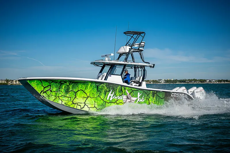 Slide: The Image of 2024 Costa Custom Boats 34 with vibrant green design cruising on open water. - 11