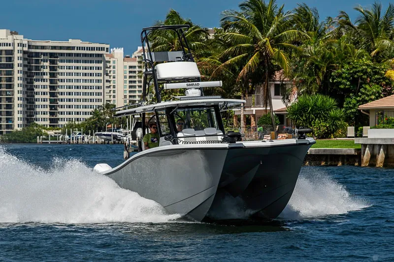 Slide: The Image of 2024 Costa Custom Boats 34 cruising on water near tropical shoreline. - 118