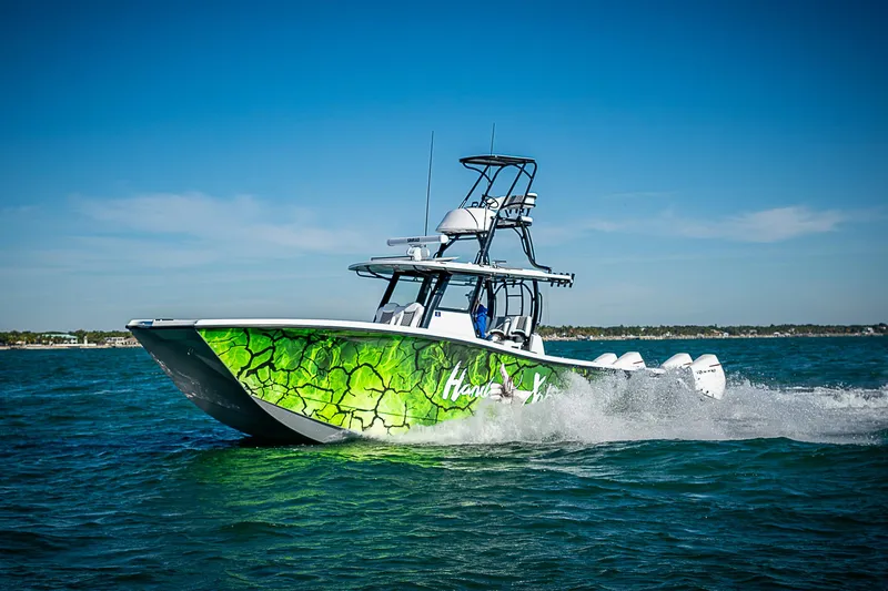 Slide: The Image of 2024 Costa Custom Boats 34 cruising on water with vibrant green hull design. - 12
