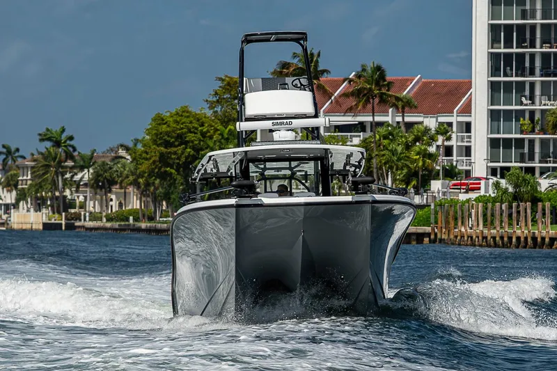 Slide: The Image of 2024 Costa Custom Boats 34 cruising on water near waterfront buildings. - 120