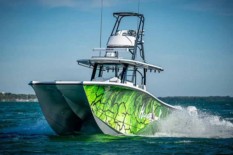 Slide: The Image of 2024 Costa Custom Boats 34 with vibrant green hull design cruising on water. - 15
