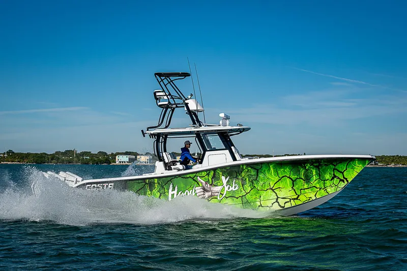 Slide: The Image of 2024 Costa Custom Boats 34 cruising on water with vibrant green hull design. - 19