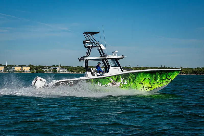 Slide: The Image of 2024 Costa Custom Boats 34 cruising on water with vibrant green hull design. - 23