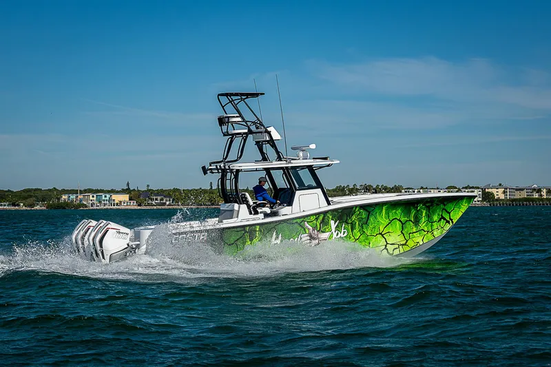 Slide: The Image of 2024 Costa Custom Boats 34 cruising on water with vibrant green hull design. - 24