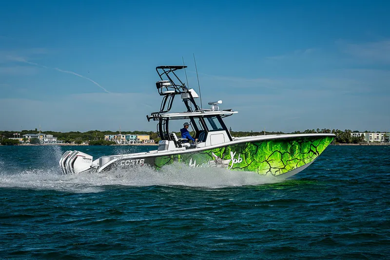 Slide: The Image of 2024 Costa Custom Boats 34 cruising on water with vibrant green design. - 25